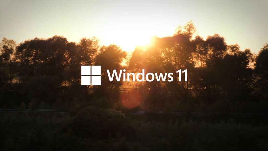 Windows 11 logo over sunset